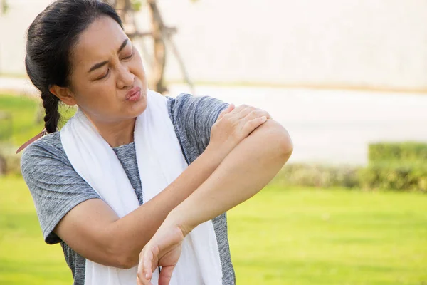 Old Asian people suffer from exercise pain. senior woman suffering from sore arm.