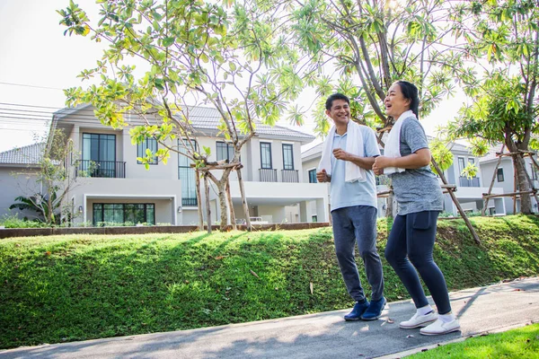 A couple of older Asian men and women wear exercise clothes before their morning exercises.Men and women jogging in the morning in the garden.