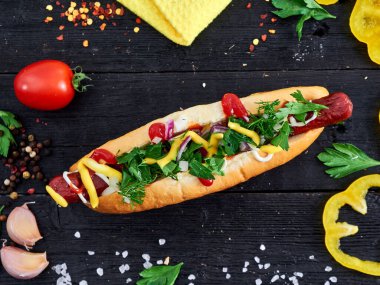 tasty Hot dog on wood with vegetables and spices