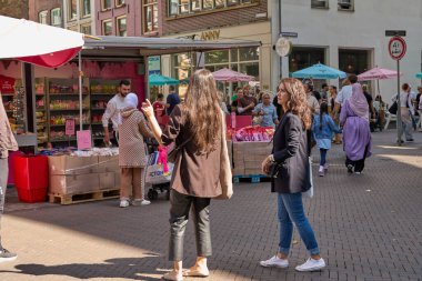 Utrecht, Hollanda - 30 Ağustos 2025 - İnsanlar kalabalık bir Avrupa şehir merkezinde bir gıda standında toplandılar                               