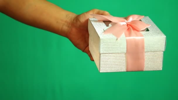 Man Giving Gift Box Someone Green Background Shooting Studio — Stock Video