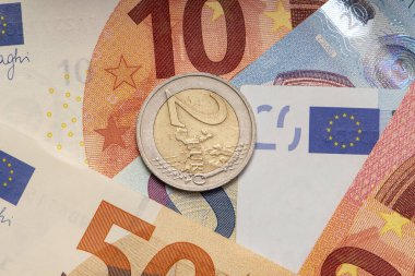 Close-up of European banknotes and 2 Euro coins,close-up, selective focus.