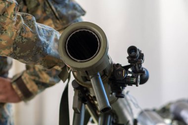 Bir asker, anti-tank silahının namlusunu yakın planda gösteriyor..