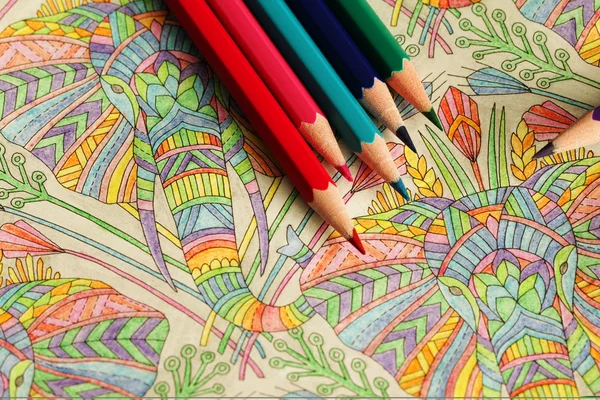 Multi-colored pencils and coloring book for adults — Stock Photo ... Multi-colored pencils and coloring book for adults — Stock Photo ...