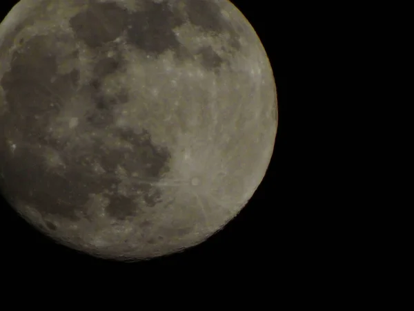 Earths Moon Glowing On Black Background