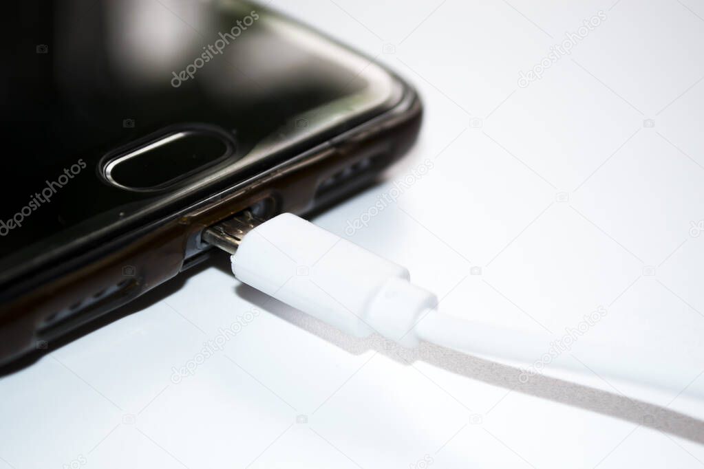 Smartphone with charger on white background,USB cable