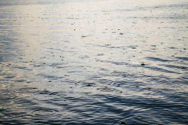 Drizzling rain on the surface of the lake, relaxin in rainy weather on the lake.