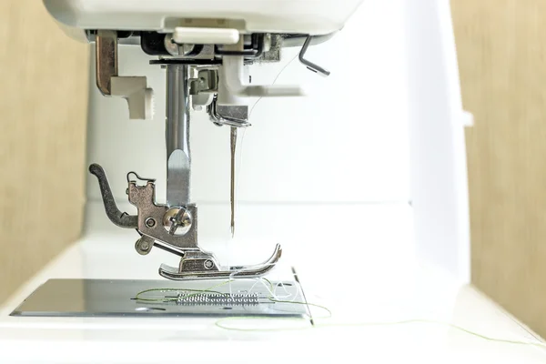 Close-up of modern sewing machine foot. Royalty Free Stock Photos