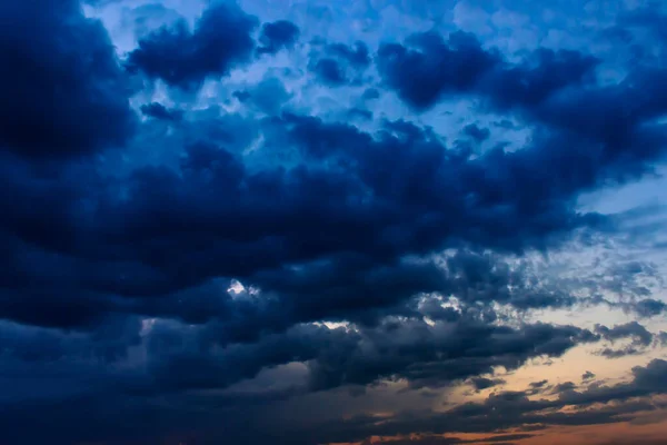 The big powerful storm clouds before a thunder-storm. Storm clouds at sunset.