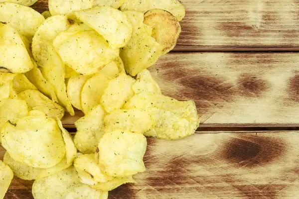 Heap of Paprika Potato Chips on rustic background — Stock Photo, Image