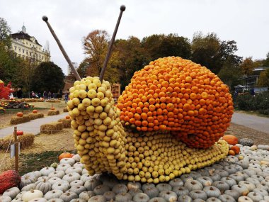 Ludwigsburg, Germany - October 27,2018 : The Big snail in pumpkin garden has a theme represented in pumpkin art in World's largest pumpkin festival.  clipart