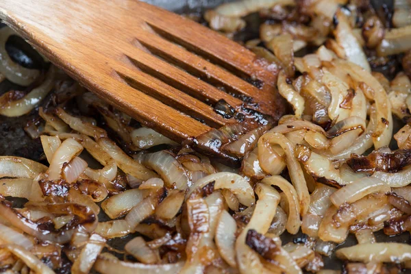 Tavada caramelizing soğan