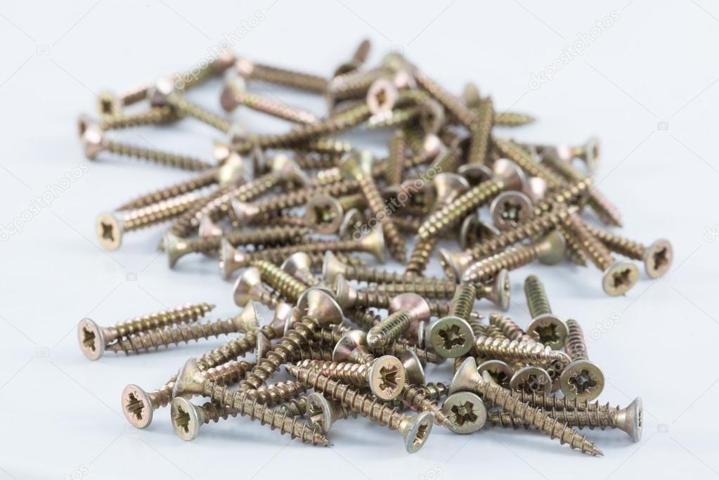 Brass screws resting on white surface
