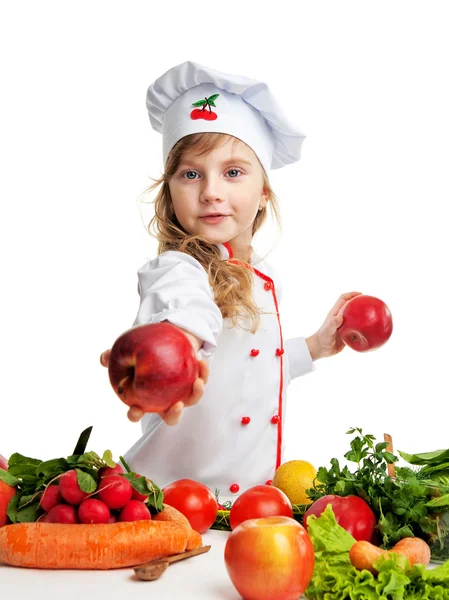 Dívka v jednotné šéfkuchař drží jablka — Stock fotografie