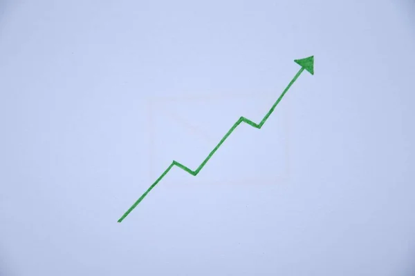 Photo Green Arrow Pointing White Paper Positive Trend Result — Stock Photo, Image