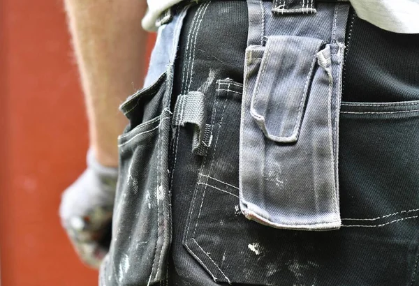Closeup of the working pants of painter or worker doing home renovation or improvement