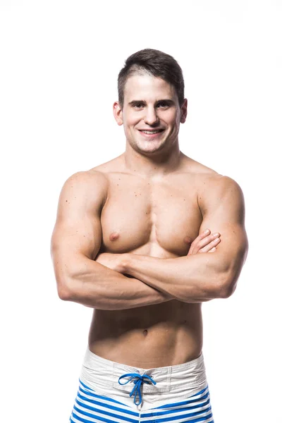 Portrait of a handsome young muscular man in swimwear with hands folded isolated on white background — Stock Photo, Image