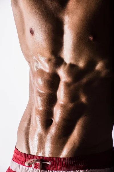 Side-view silhouette of young muscular athletic sexy shirtless hot man posing showing wet sport body with cool pectoral abs muscle strong breast biceps studio on white. Beads sweat training gym. — Stock Photo, Image
