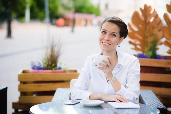 Elegante mujer hermosa con portátil beber café en la cafetería — Foto de Stock