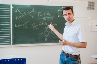 Kara tahta sınıfa konuşmak okul sınıf yakınındaki genç öğretmen