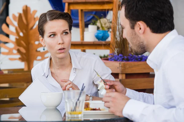 Successful manager sitting at business lunch with colleague and giving instructions to her — Stock Photo, Image