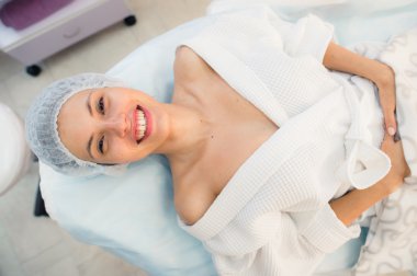 beautiful patient woman smile lying on bed in surgery room hospital clipart