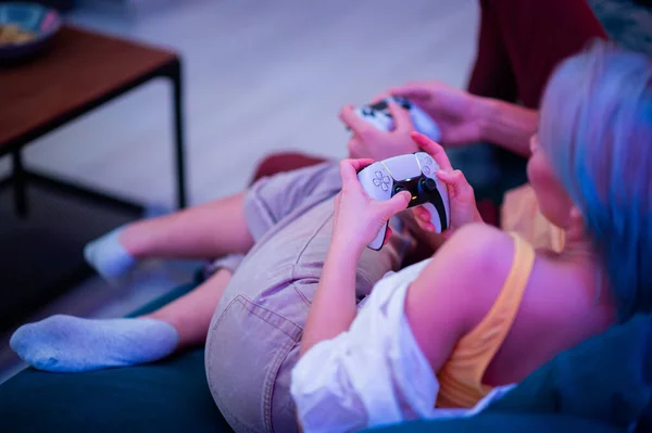 Different generations of PlayStation console controllers: PS5 DualSense controller and PS4 DualShock controller in a hands of gamers. Moscow - November 28 2020. — Stock Photo, Image