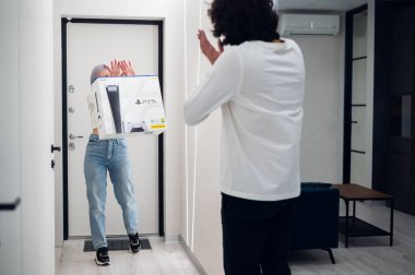 Mutlu, heyecanlı kadın yeni Sony PlayStation 5 oyun konsoluyla sevgilisine sürpriz yapmak için eve geliyor. Noel için almıştı. Moskova - 28 Kasım 2020