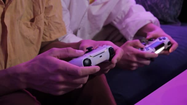 Close view of a gamers hands playing video games on console using joystick. — Stockvideo