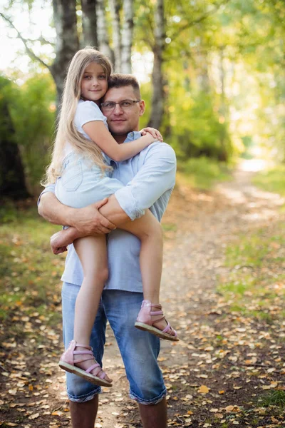 A father and daughter in forest on a meadow — Stock Photo, Image