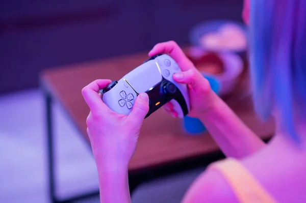 Girl with next gen controller in her hands playing games at home. — Stock Photo, Image