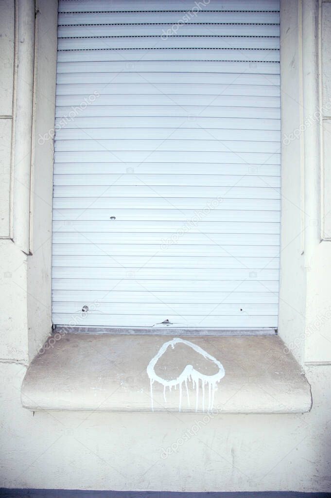 Heart graffiti upside down on windowsill  with closed shutters above, symbol of unfulfilled love - All about Love