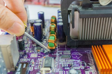 Teknisyen tornavida ile sabitleme mainboard eller