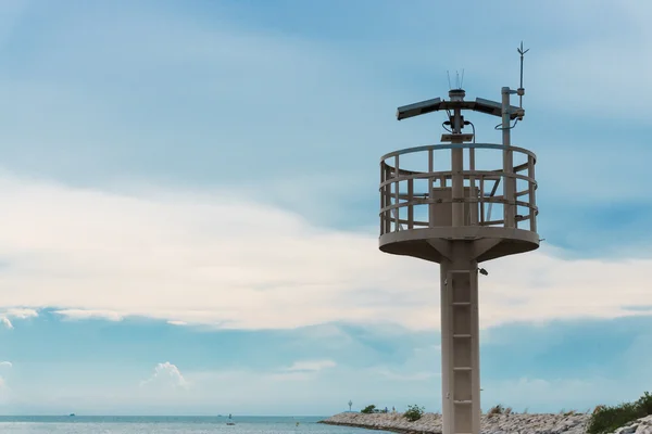 Lighthouse and breakwater formed by concrete blocks — Stock Photo, Image