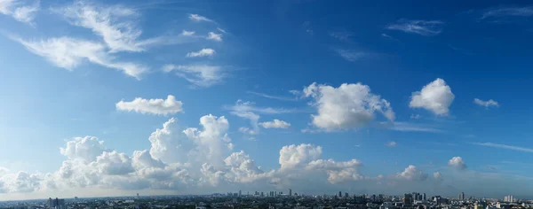 Langit biru dan awan putih di atas pemandangan kota — Stok Foto