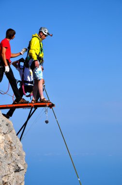 spotsman rope jumping off the cliff clipart