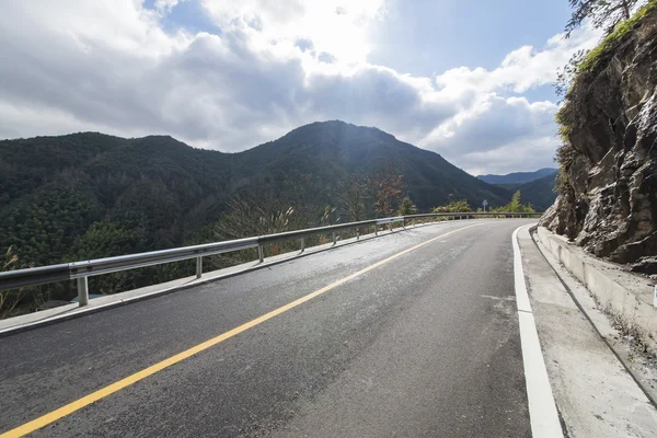 Snelweg weg met dramatische wolken — Stockfoto