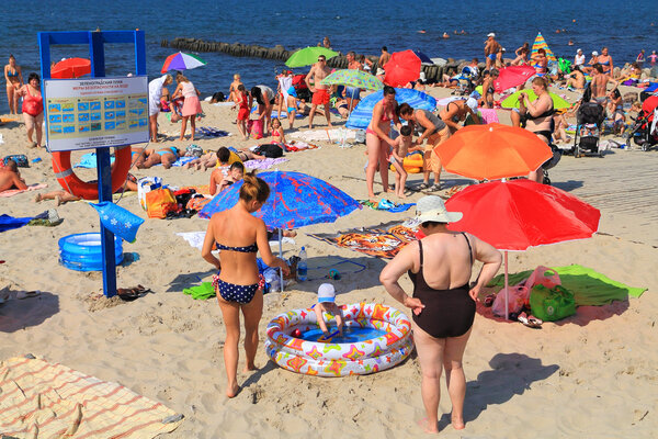 People families have a rest on the sandy coast of the Baltic Sea