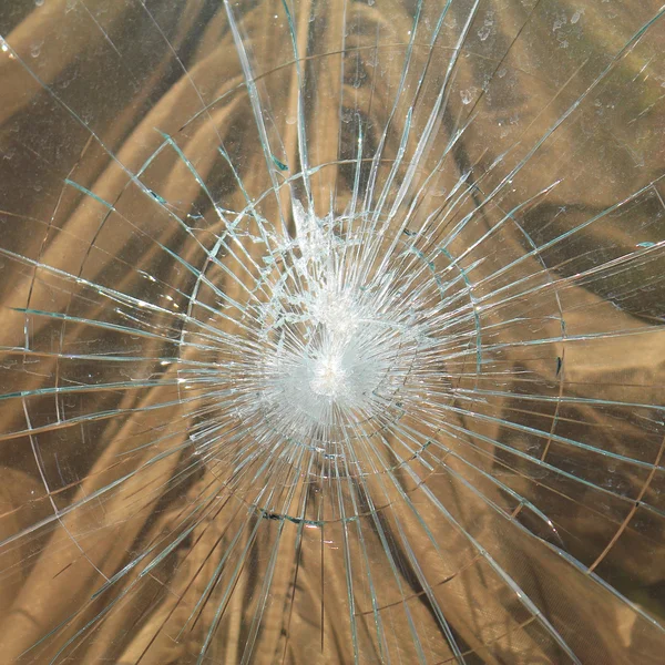 Beaten glass with many cracks — Stock Photo, Image