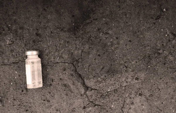 There is an empty medicine bottle on the floor