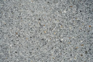 Granit kırıntılarından oluşan bir duvar dokusu arka plan gibidir..