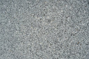Granit kırıntılarından oluşan bir duvar dokusu arka plan gibidir..