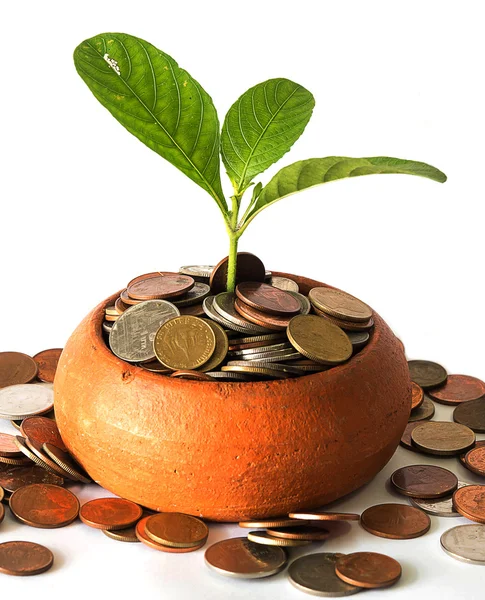 Coins in pottery bowl and out of around bowl. — Stock Photo, Image