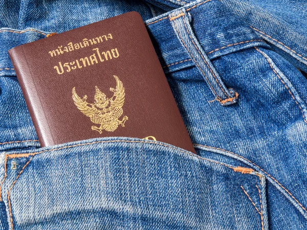 Pasaporte de Tailandia en el bolsillo trasero de vaqueros viejos . — Foto de Stock