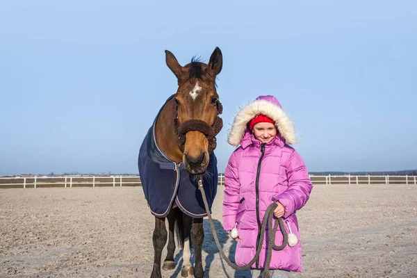 Horse and girl baby. Make friends with an animal