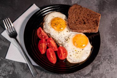 Kızarmış yumurta ve tost, ekmek, domates, lezzetli kahvaltı, aperatif, yumurta sarısı ve protein yiyecekler, arka plan, üst görüş, fotokopi alanı, sağlıklı hammaddeler. Çırpılmış yumurta. Kahvaltıda. Sağlıklı beslenme. Yakın plan.