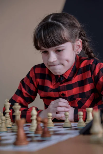 The girl at the chessboard. Competition. Chess tournament. The girl plays chess. Game of chess. Portrait