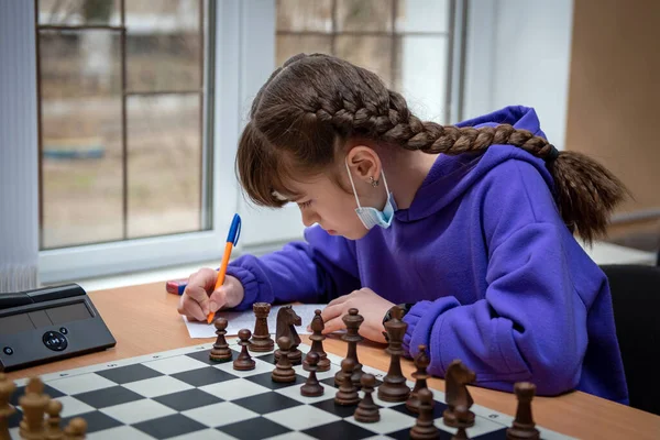 A girl plays chess. Game of chess. Tournament