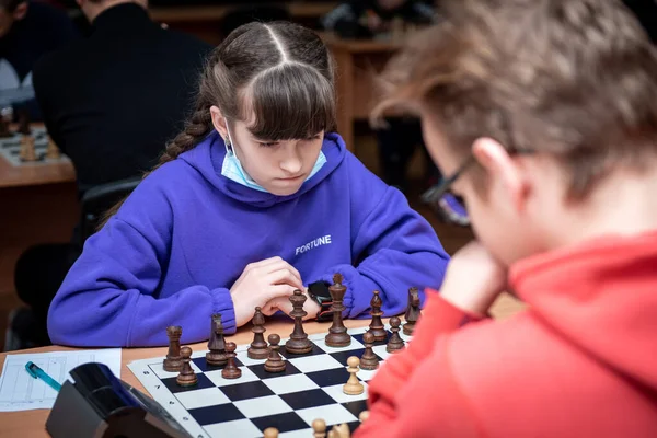A girl plays chess. Game of chess. Tournament