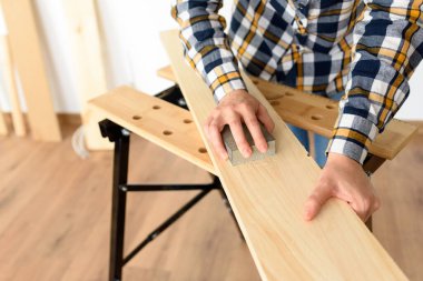 Evdeki bir kadının tezgahtaki tahtayı zımparalarken yakın plan fotoğrafı. Yüksek kalite fotoğraf.